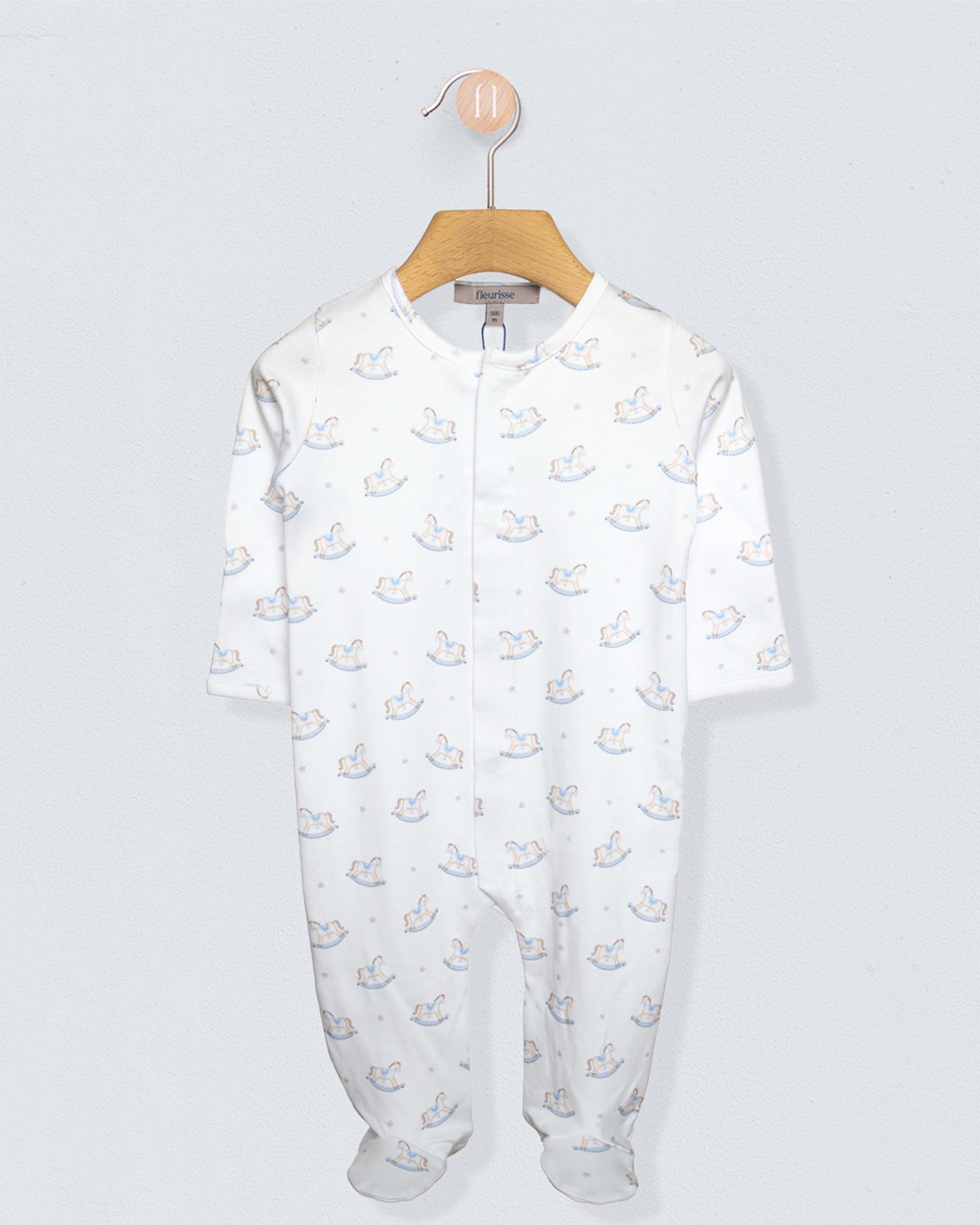 white stretchie with blue and brown rocking horses against a grey background