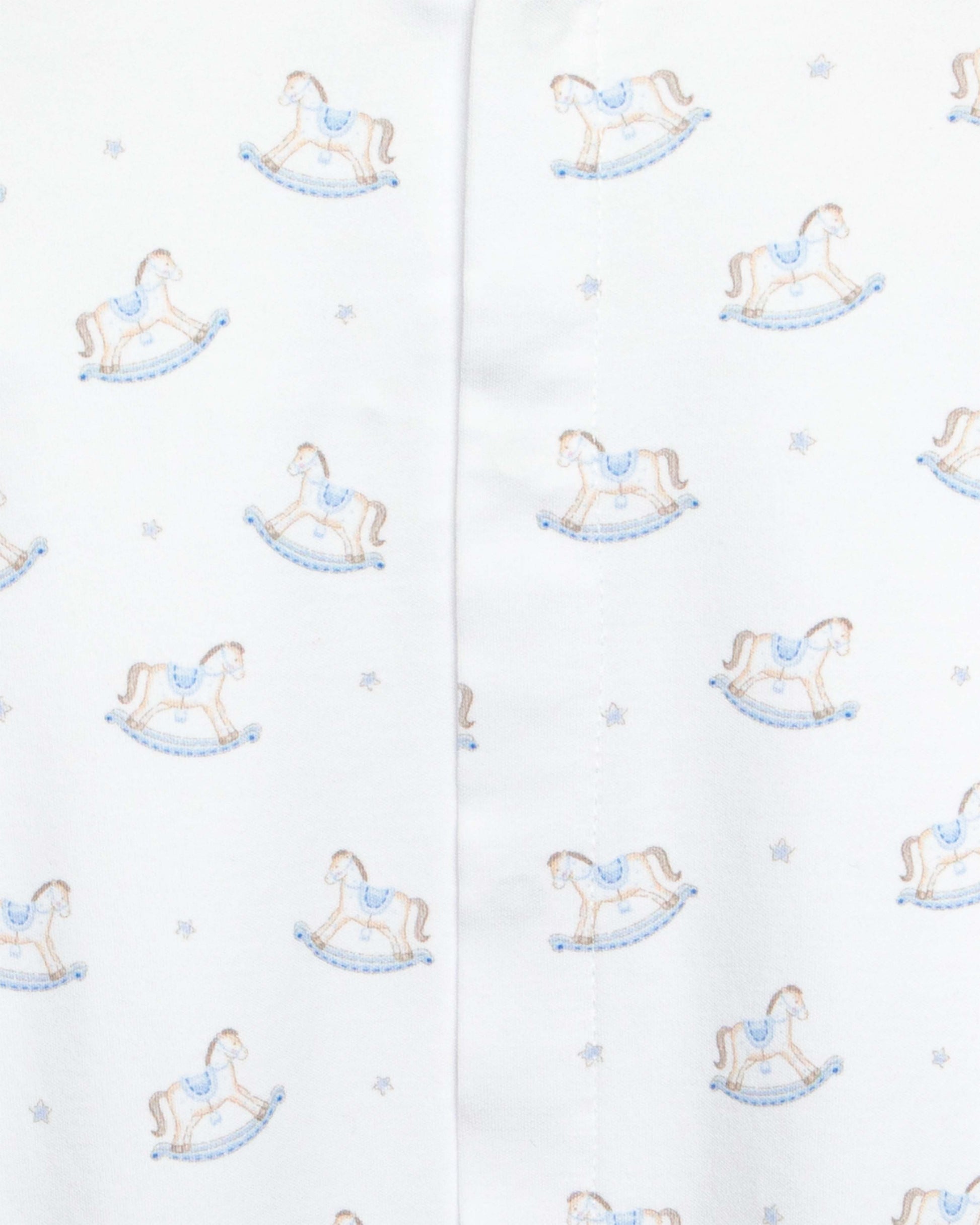 close up of white stretchie with blue and brown rocking horse designs