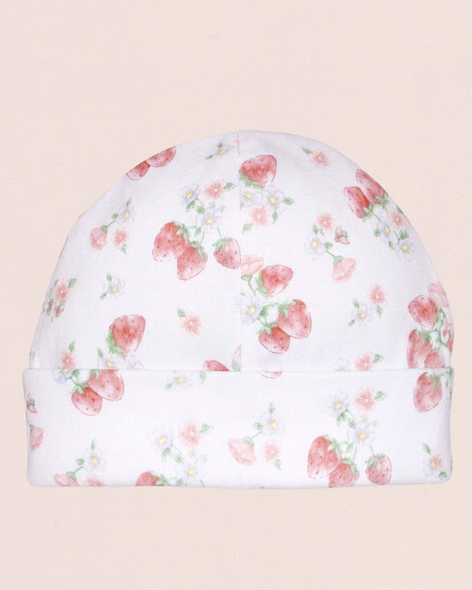 Floral patterned baby hat with strawberries on a beige background