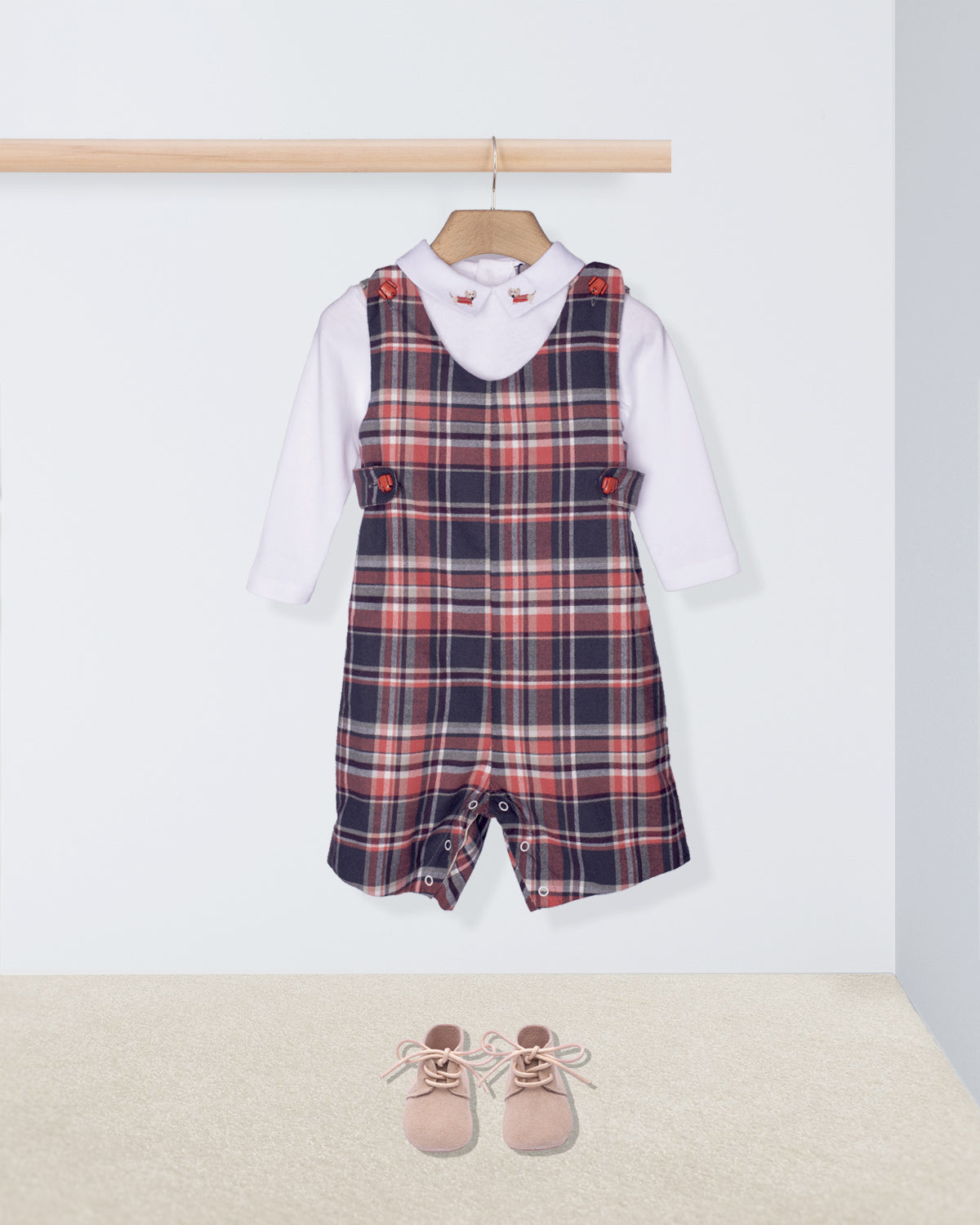 Plaid romper with white shirt and pink shoes on a white background