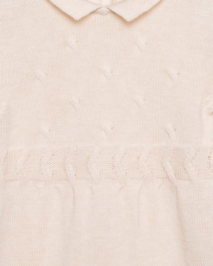 Close-up of a textured beige romper with a collar.