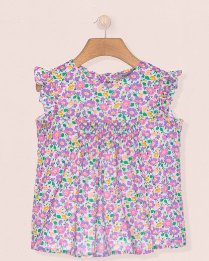 Floral dress on a hanger against a beige background