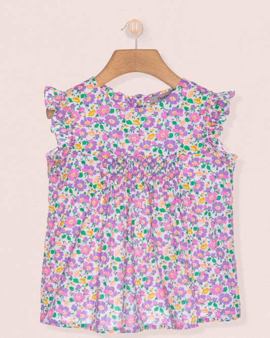 Floral dress on a hanger against a beige background