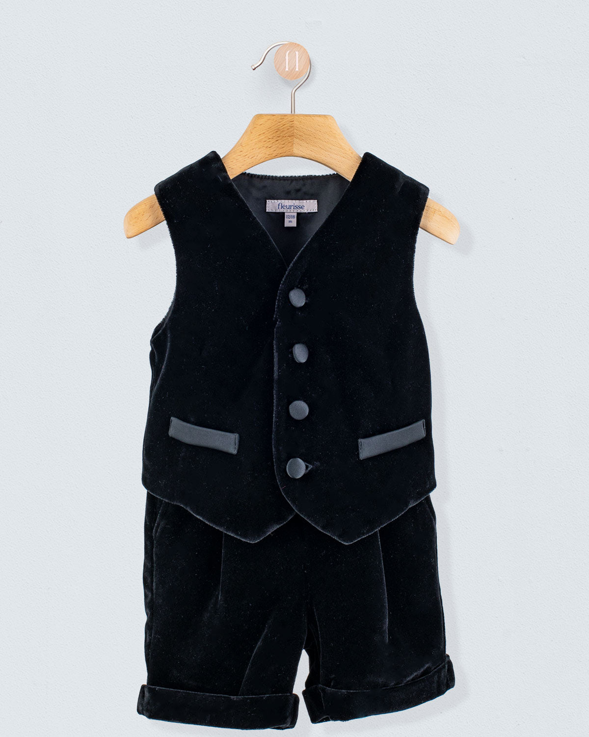 Adam 2-Piece Black Velvet Vest and Suspender Shorts, infant-sized, featuring a sleeveless V-neck vest with buttons and matching shorts with turned-up cuffs and suspenders.