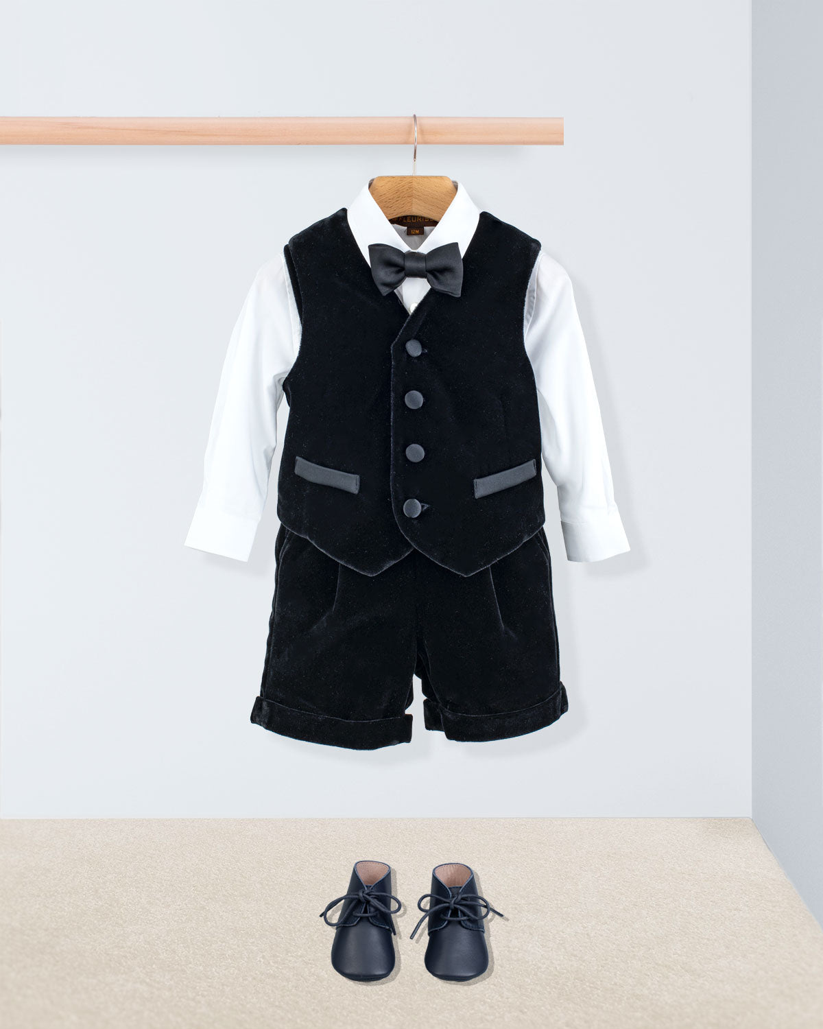 Adam 2-Piece Black Velvet Vest and Suspender Shorts, featuring a white dress shirt, black bow tie, and black lace-up dress shoes, elegantly displayed.