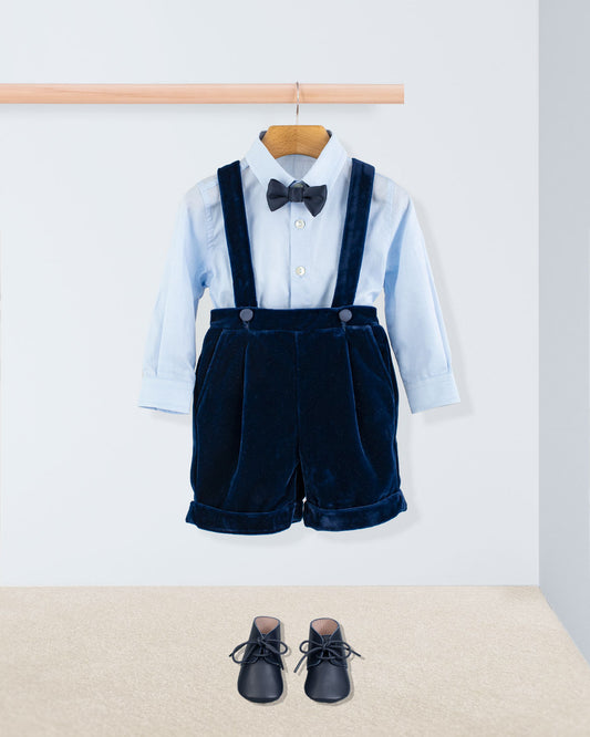 Adam Navy Velvet Suspender Short paired with a light blue shirt, black bow tie, and navy lace-up shoes, showcasing elegant Italian craftsmanship for special occasions.