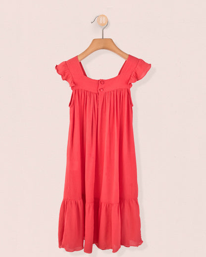 Back view of coral girl's dress showing tonal buttons and gathered detailing