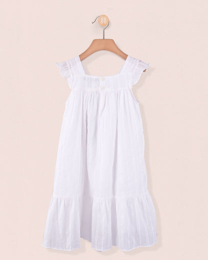 Back view of girl's dress in white showing tonal buttons and gathered detailing