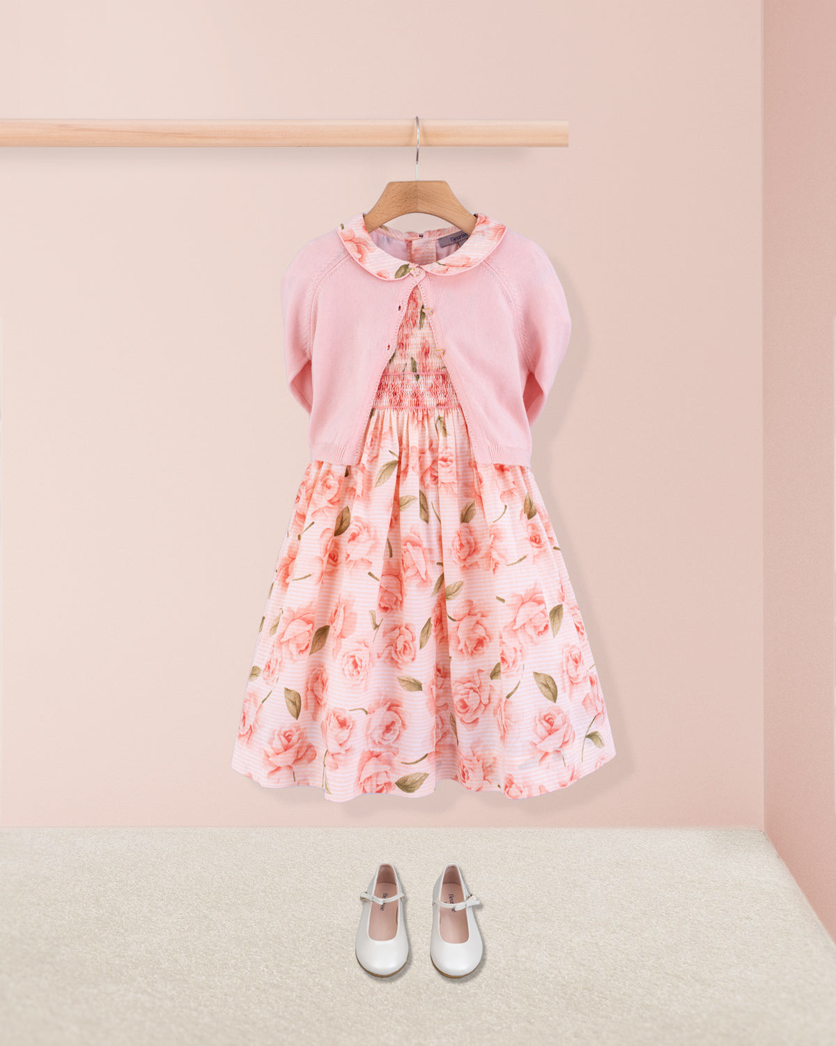 Amanda Bianca rose smock dress paired with pink cardigan and cream Mary Jane shoes