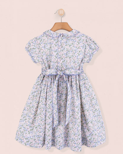 Back view of Amanda Lauren Blue Floral Smocked Dress on hanger