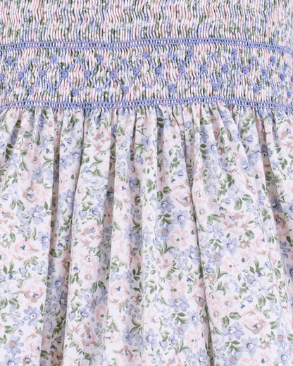 Close-up of smocking and floral fabric on Amanda Lauren Blue Floral Smocked Dress