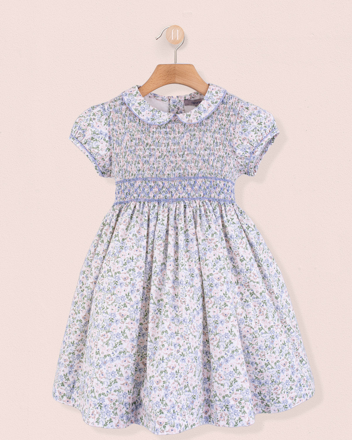 Front view of Amanda Lauren Blue Floral Smocked Dress on hanger