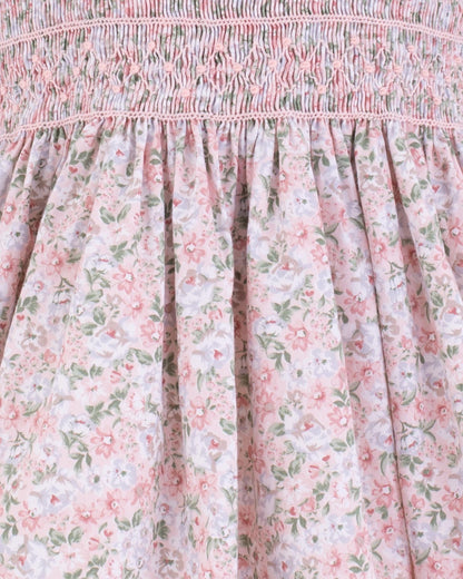 Close-up of pink smocked bodice with floral fabric detail