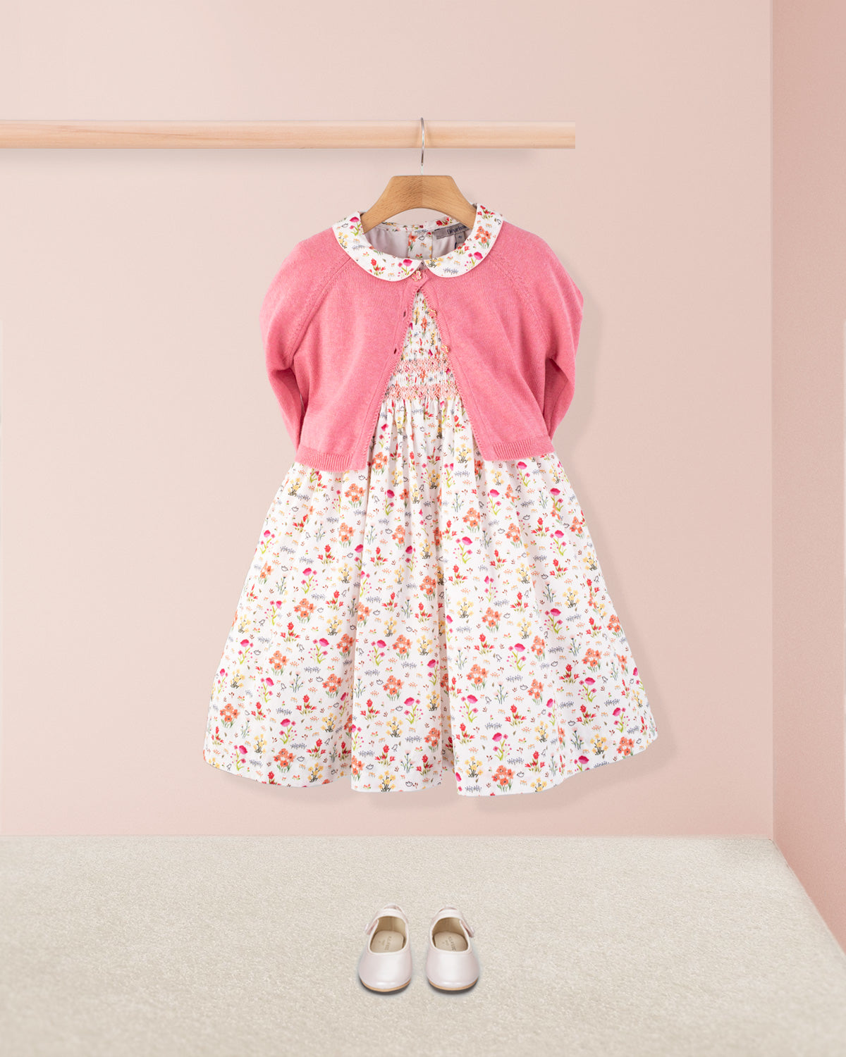 Amanda Happy Garden Smocked Dress styled with pink cardigan and white shoes