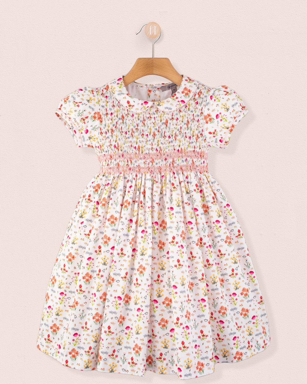 Amanda Happy Garden Smocked Dress front view on hanger in floral print