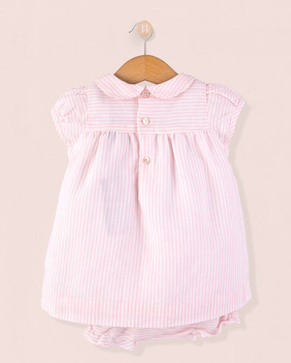 Back view of Baby Eva 2-piece outfit showing three shell buttons at the yoke and matching striped diaper cover, displayed on a hanger against a soft pink background.