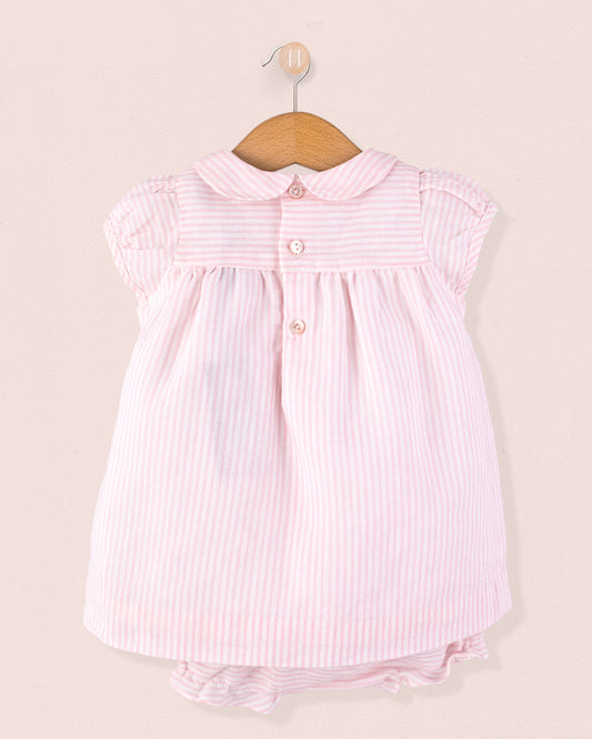 Back view of Baby Eva 2-piece outfit showing three shell buttons at the yoke and matching striped diaper cover, displayed on a hanger against a soft pink background.