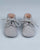 Front view of a pair of grey suede crib shoes with tied laces.