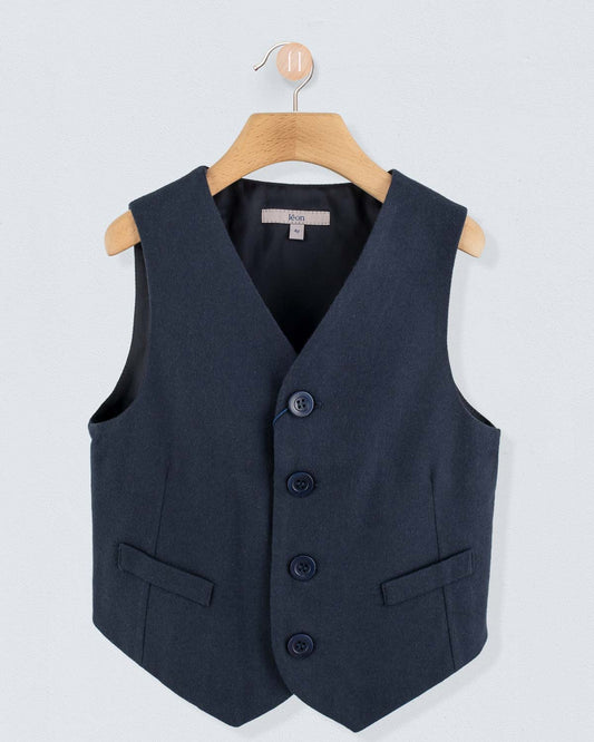 Navy virgin wool vest, displayed on a wooden hanger against a light background