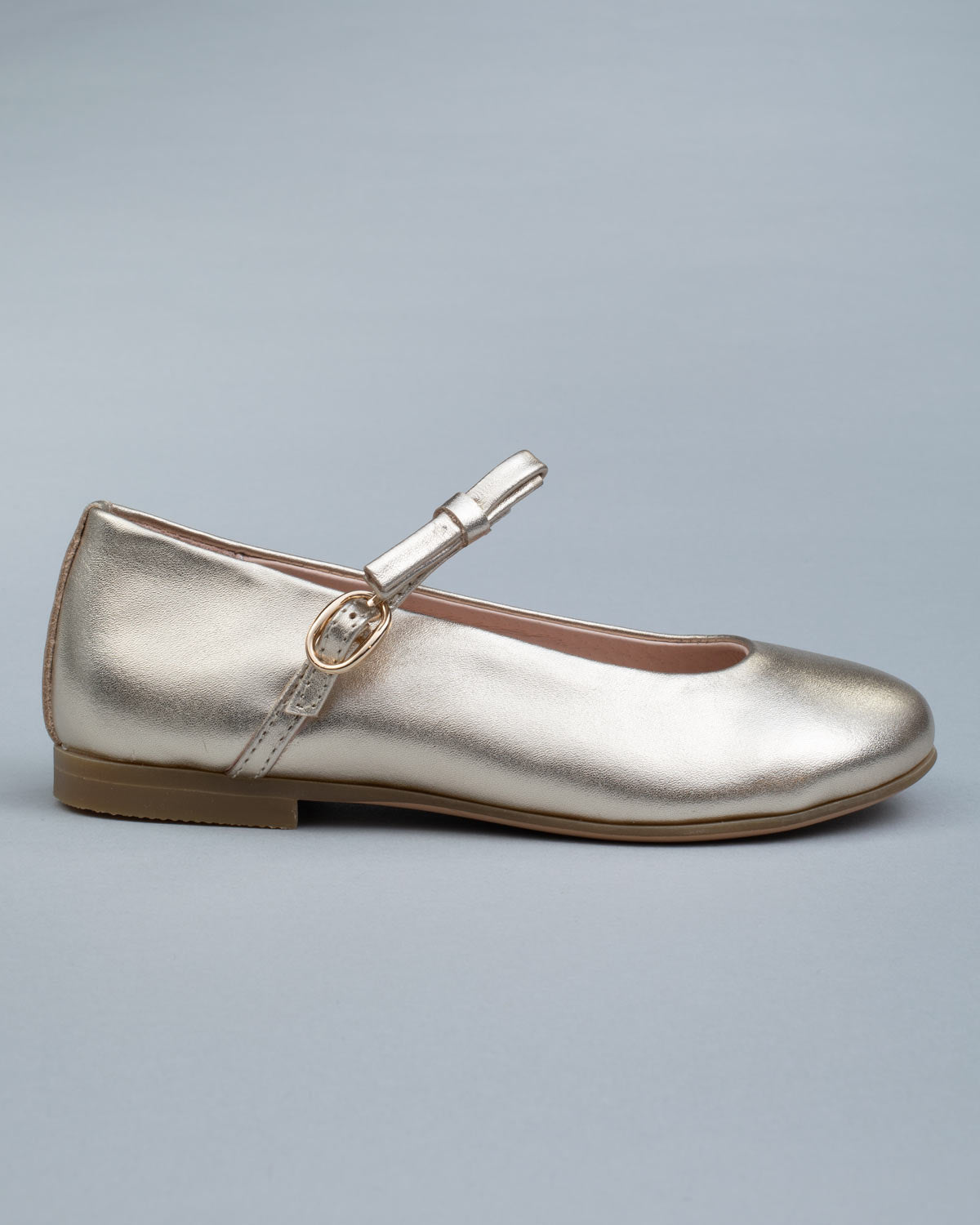 Single gold leather Mary-Jane shoe for kids shown from the side, featuring a soft bow and a secure buckle strap.
