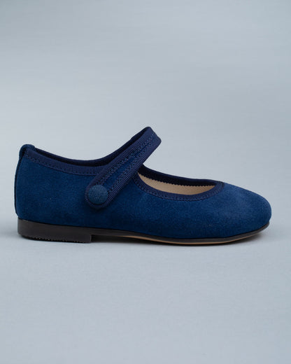 Side profile of a single Elizabeth Twilight Blue Suede Mary-Jane shoe showing velcro strap and soft suede texture.