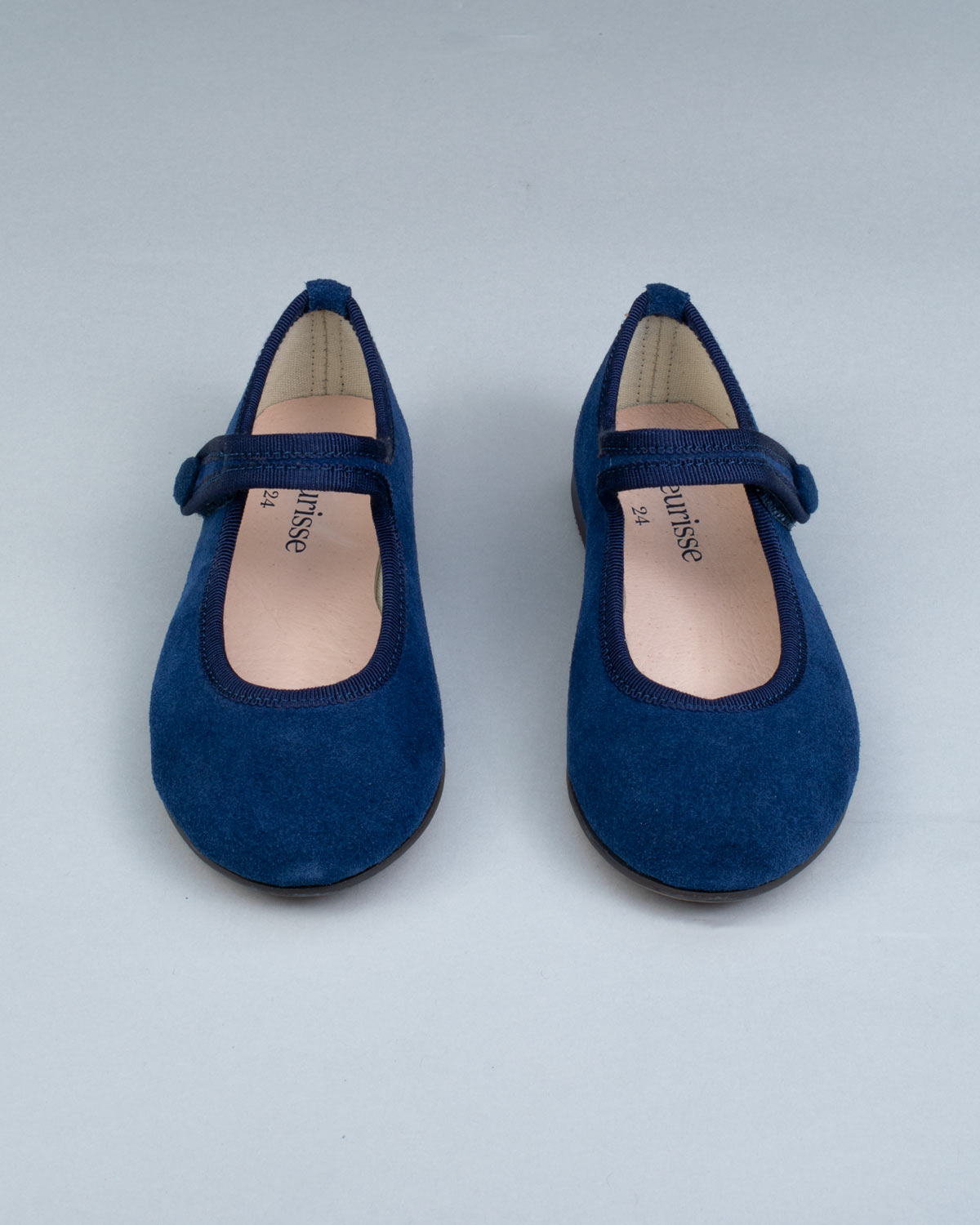 Top view of Elizabeth Twilight Blue Suede Mary-Jane shoes showing insoles and secure velcro straps, laid out evenly.