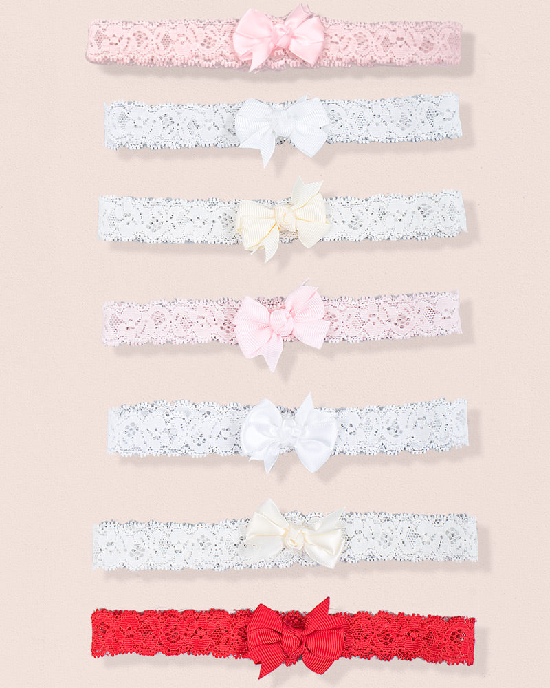 Eight lace baby headbands in various colors, each with either a satin or grosgrain bow