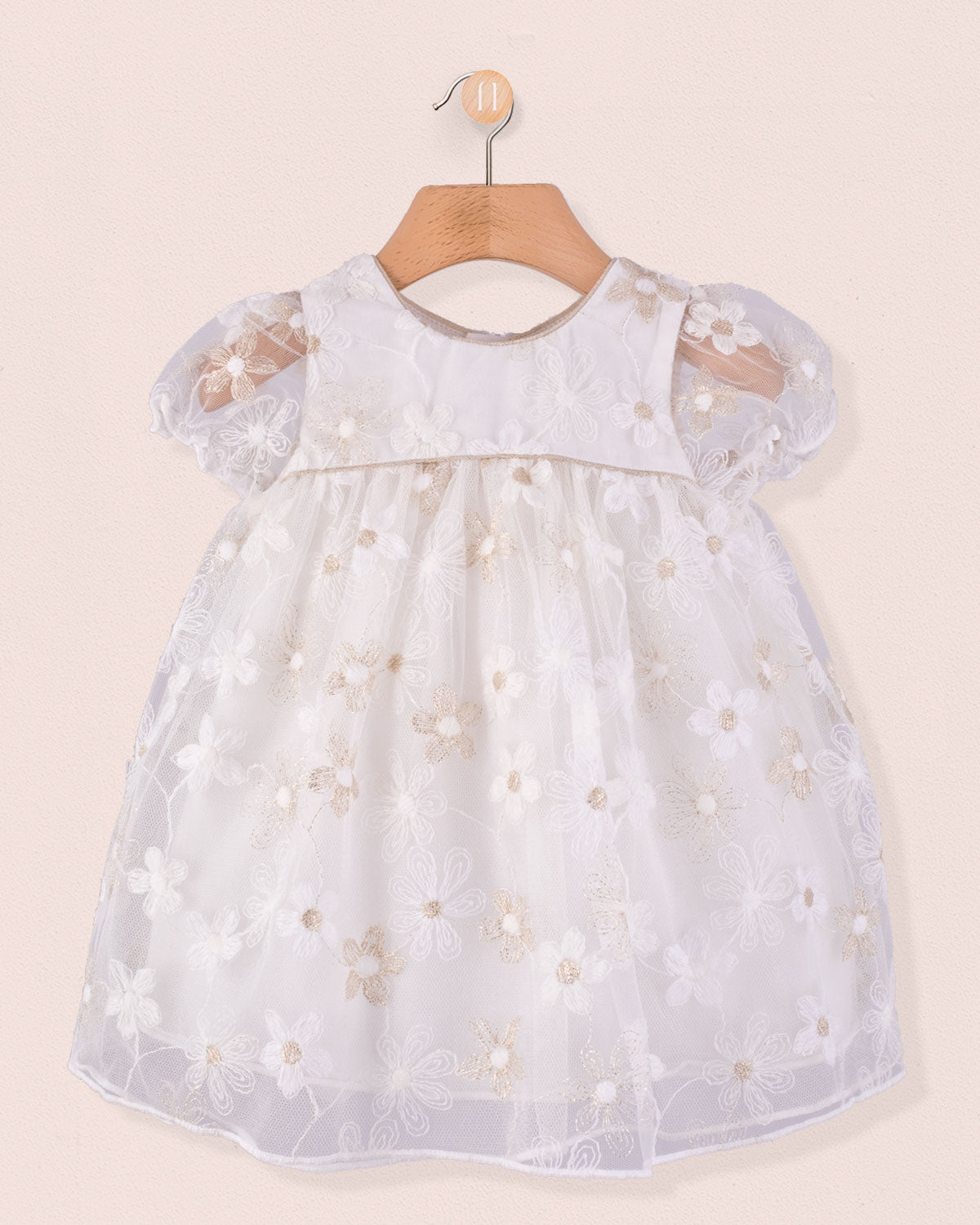 Front view of Baby Isodora Embroidered Cream Tulle Dress featuring short puff sleeves, delicate floral embroidery, and soft mesh overlay, displayed on wooden hanger.
