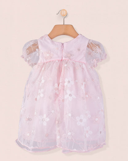 Back view of Baby Isodora pink Tulle Dress with embroidered mesh overlay, zipper closure, and gathered waist, hung on a wooden hanger.