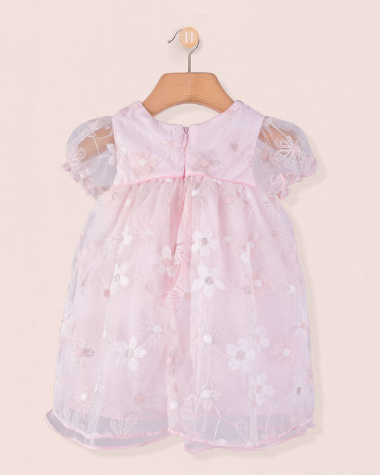 Back view of Baby Isodora pink Tulle Dress with embroidered mesh overlay, zipper closure, and gathered waist, hung on a wooden hanger.