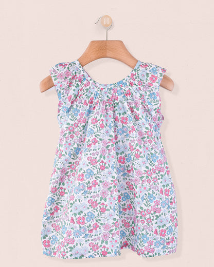 Sleeveless floral shift-style tunic in Liberty of London cotton on wooden hanger.