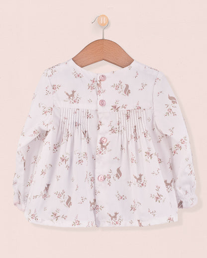 Back view of white tunic with pink deer and floral print, showing fabric-covered buttons and pleats