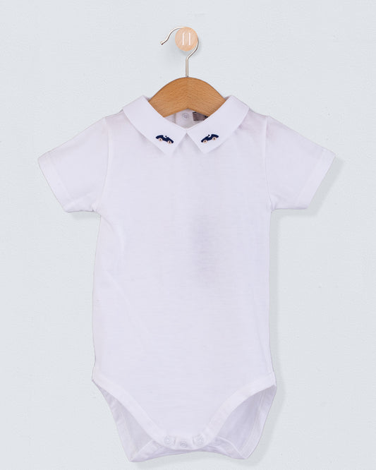 Front view of the Andreas Baby Onesie, a short-sleeve white cotton jersey bodysuit with a pointed collar featuring embroidered navy cars.