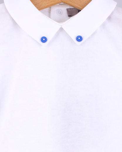 Close-up of the Andreas Onesie collar showing two small medium blue corzo buttons stitched into the tips of the white collar.