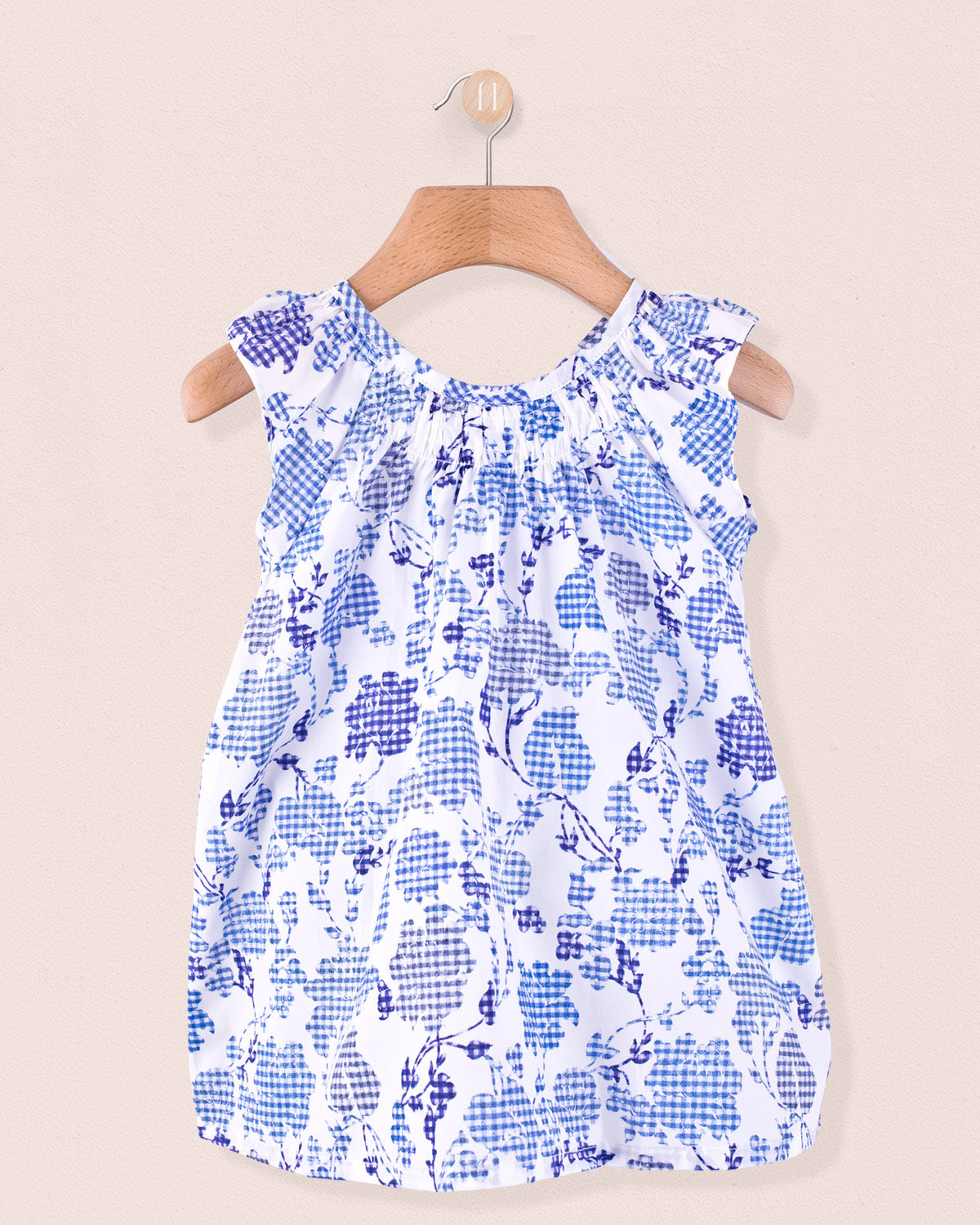 Alicia Connecticut Royal Tunic in white with royal blue floral pattern, displayed on a wooden hanger.