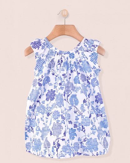 Alicia Connecticut Royal Tunic in white with royal blue floral pattern, displayed on a wooden hanger.