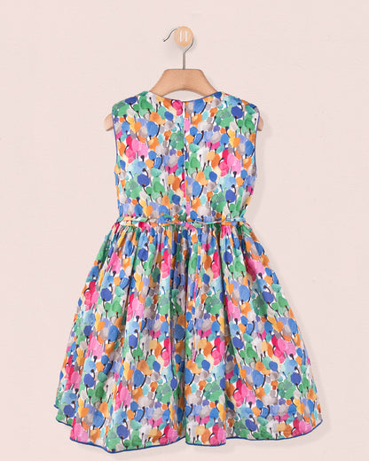 ack view of the Amandine Liberty Tulip Fields Blue Smock dress showing a zip closure and the same vibrant tulip Liberty print, displayed on a wooden hanger.